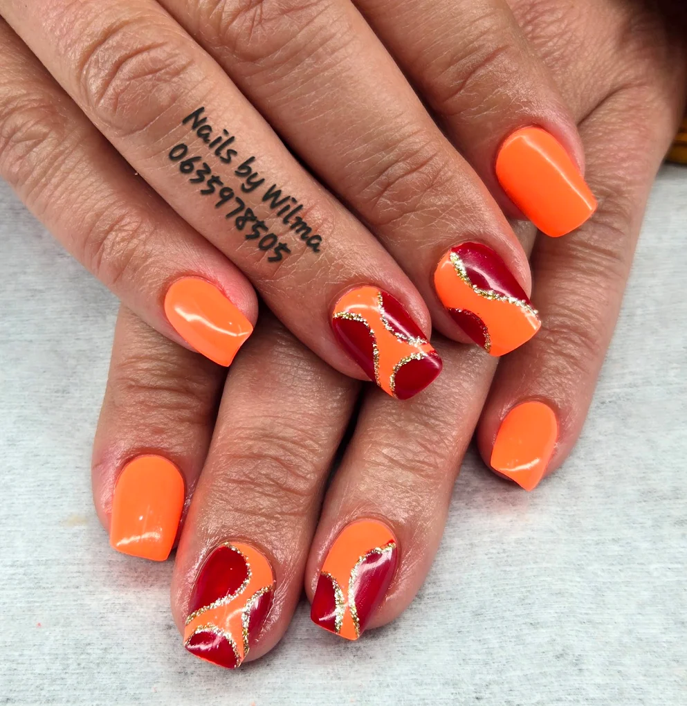 Long acrylic nails with mixed pastel colors and glitter accents