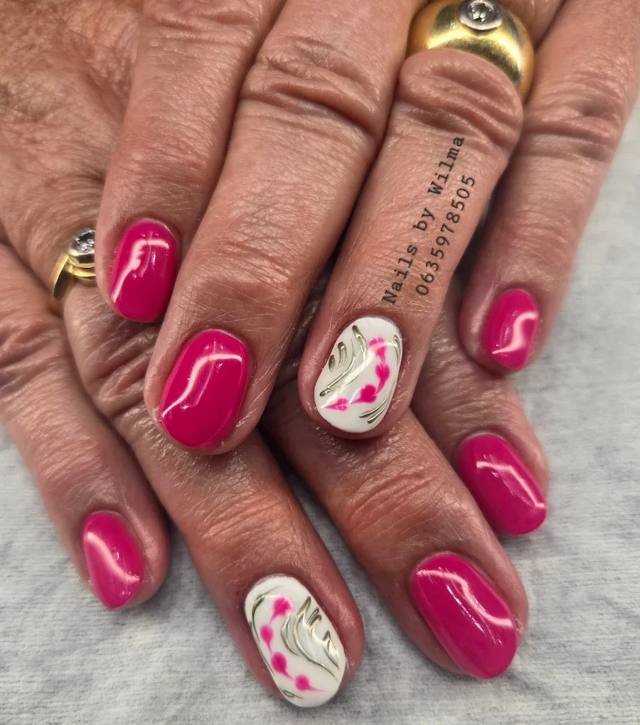 Vibrant hand-painted floral nail art on a pink base